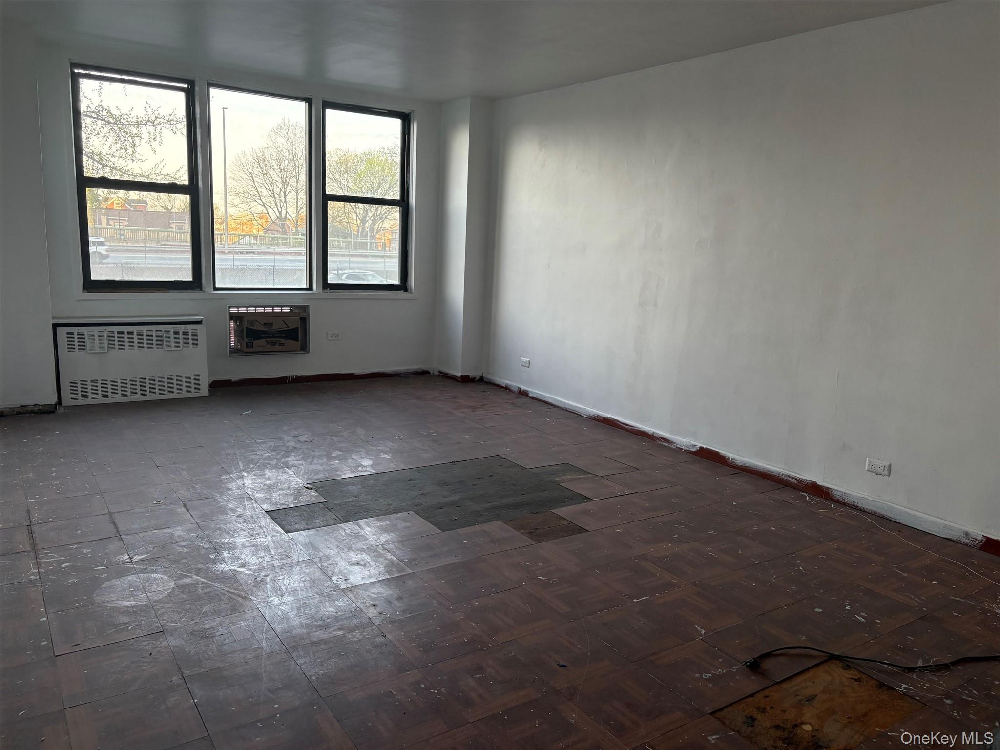 3121 Middletown Road, Unit 1G Bronx, NY 10461 - Photo 16 of 19 an empty room with a fireplace and windows