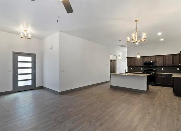 a view of kitchen with sink and wooden floor