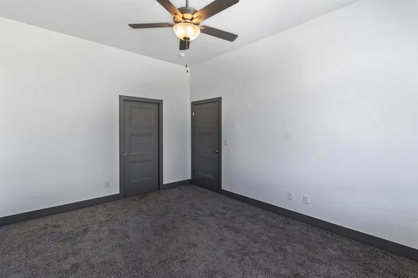 an empty room with a empty space and a ceiling fan
