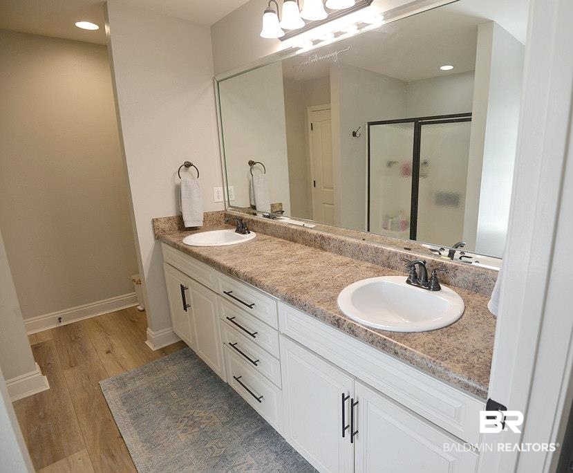 11201 Herschel Loop Daphne, AL 36526 - Photo 24 of 32 Bathroom with vanity, an enclosed shower, toilet, and wood-type flooring