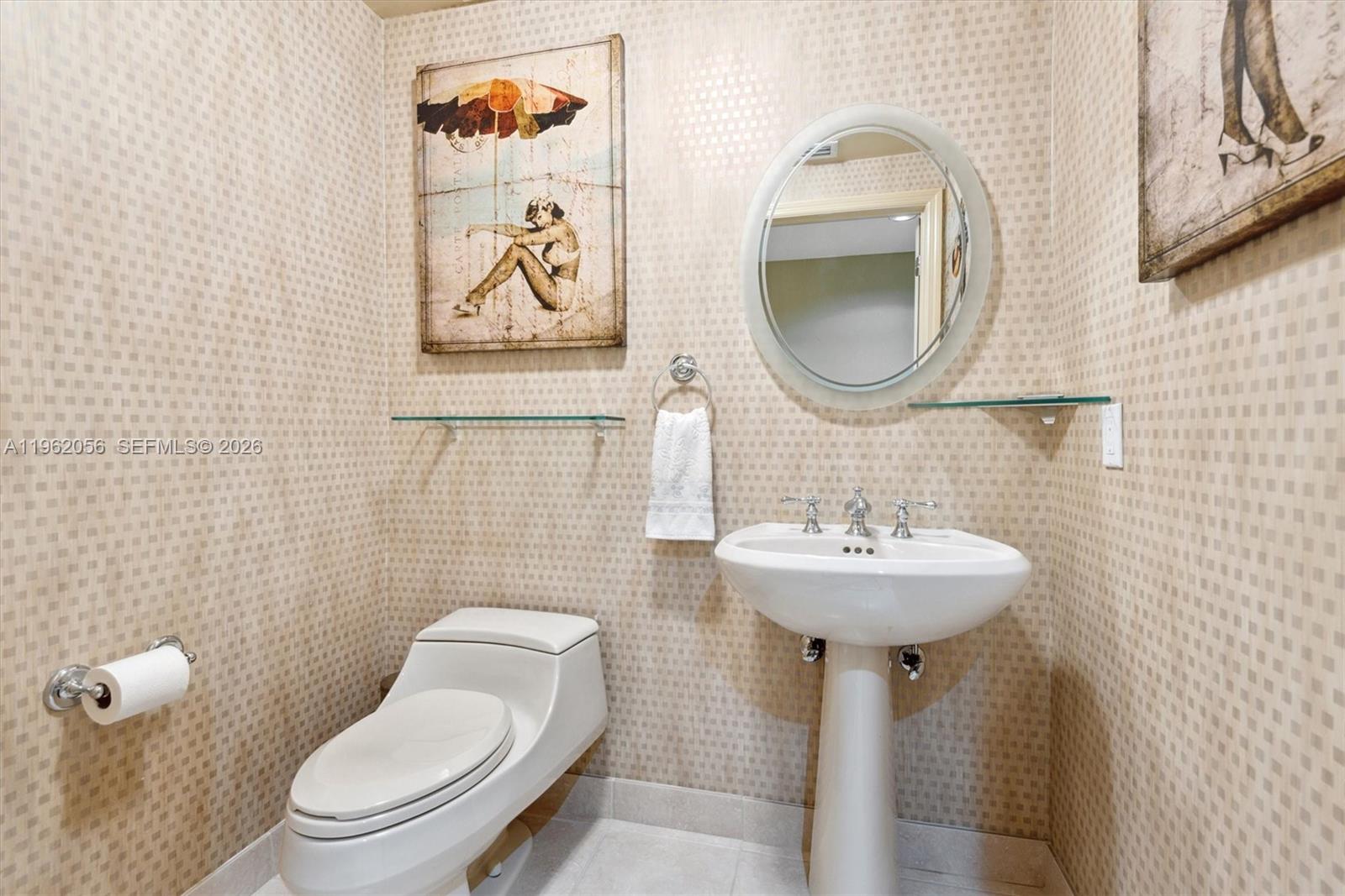 Hollywood Hollywood, FL 33019 - Photo 14 of 31 a bathroom with a toilet sink and mirror