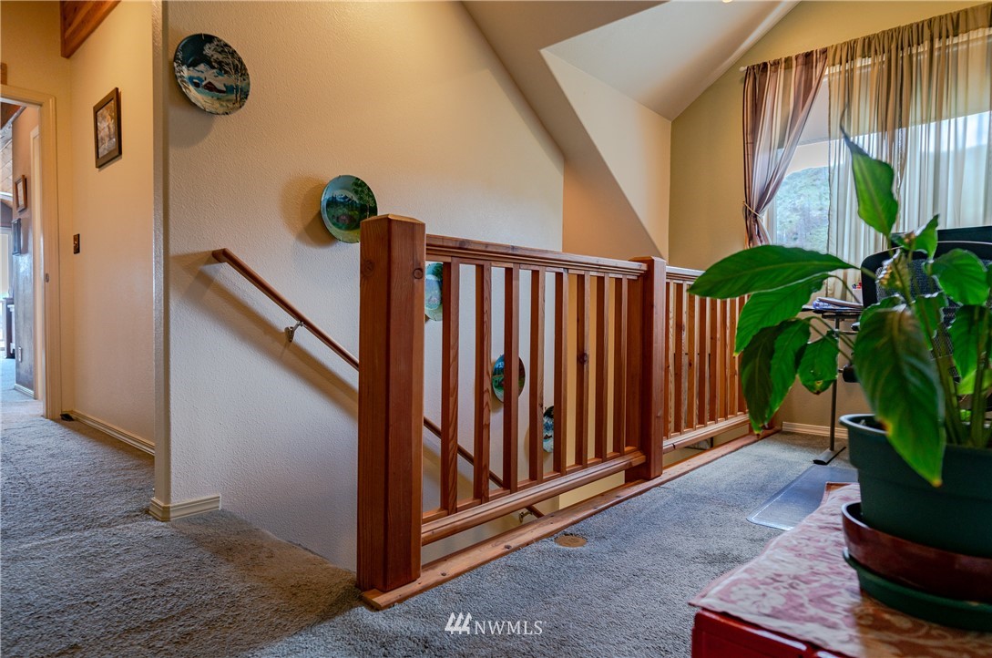 28 Alkali Lake Road Riverside, WA 98849 - Photo 22 of 35 a view of a hallway with wooden floor and stairs