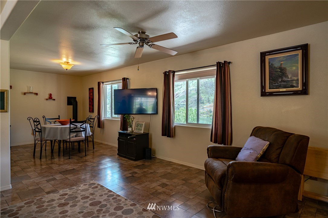 28 Alkali Lake Road Riverside, WA 98849 - Photo 8 of 35 a living room with furniture and a flat screen tv