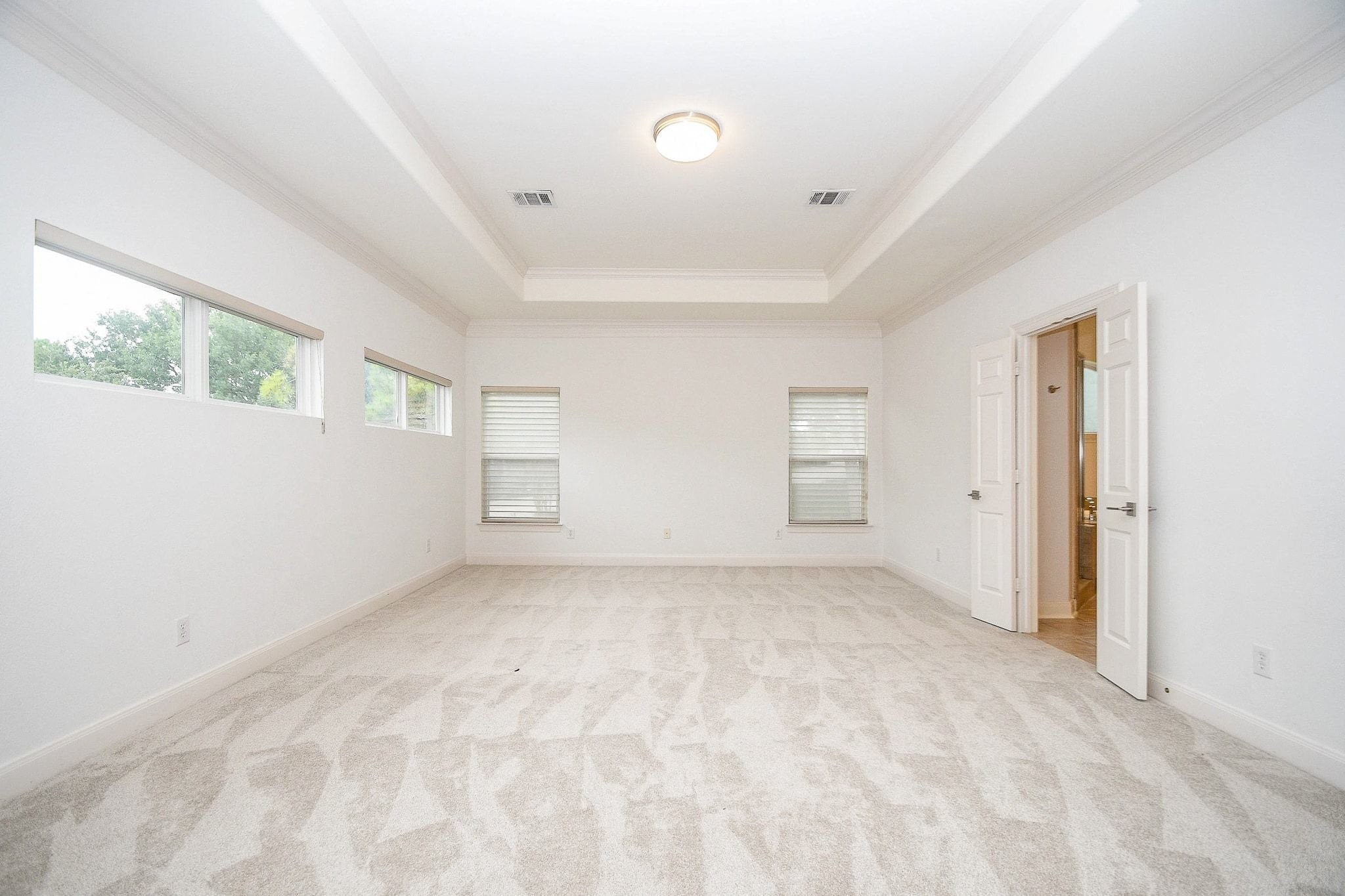 2826 Tudor Manor Houston, TX 77082 - Photo 17 of 37 This spacious primary bedroom is located on the second floor and features new carpet and large private windows that invite an abundance of natural light.