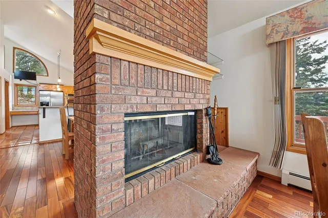 a living room with a fireplace furniture and a wooden floor