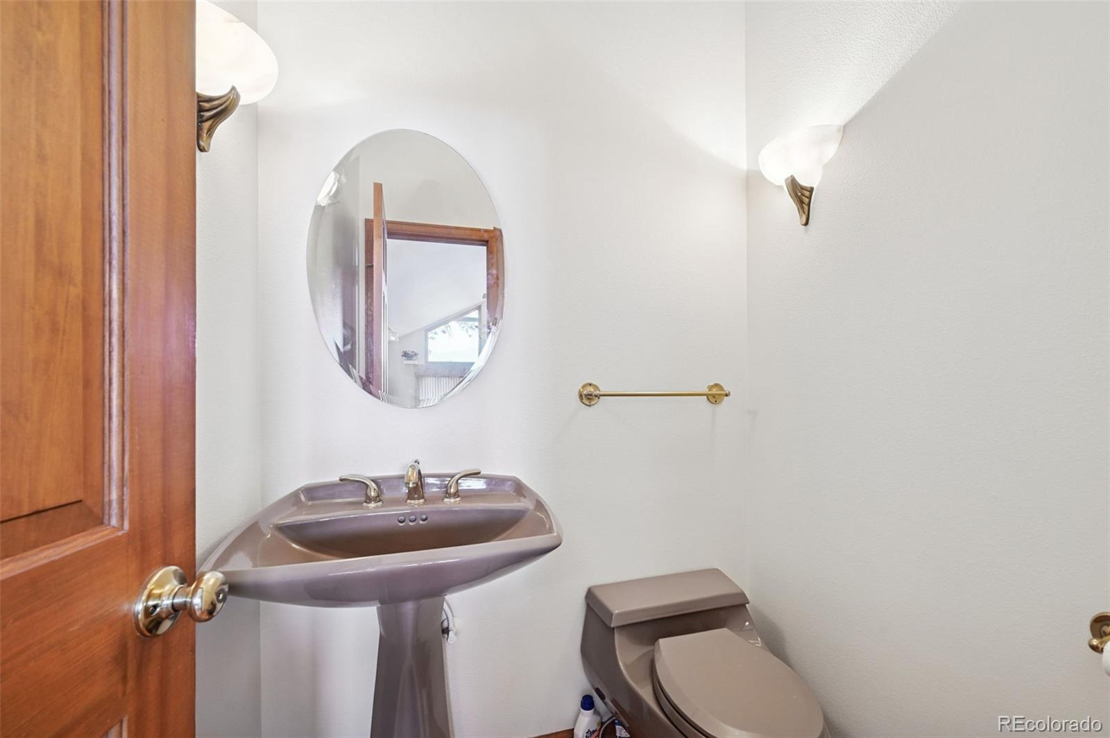 17580 Chipped Arrow Way Monument, CO 80132 - Photo 27 of 47 a bathroom with a toilet a sink and mirror