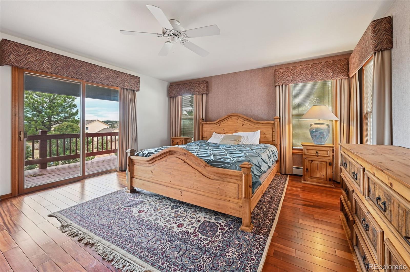 17580 Chipped Arrow Way Monument, CO 80132 - Photo 29 of 47 a bedroom with a large bed and a large window