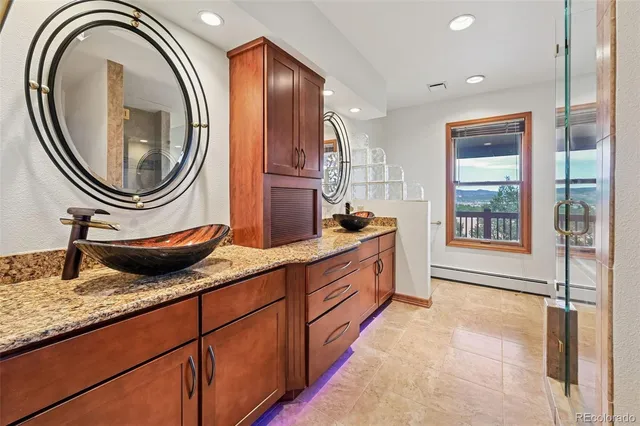 a bathroom with a tub a sink and glass door shower