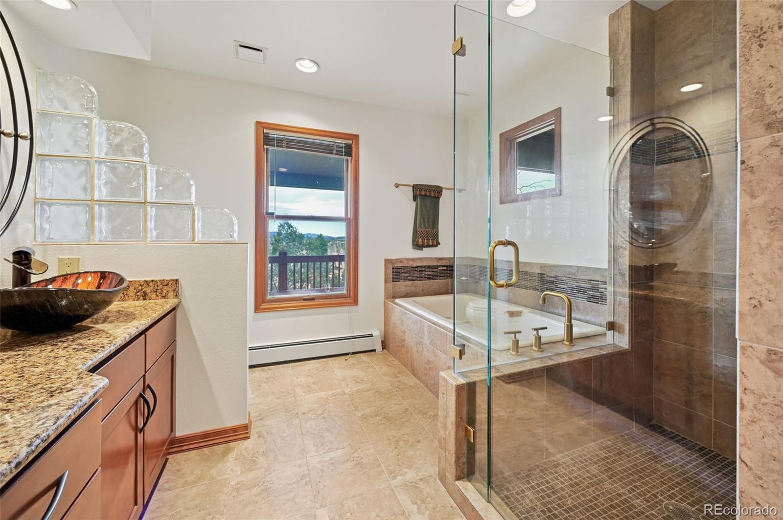 17580 Chipped Arrow Way Monument, CO 80132 - Photo 32 of 47 a kitchen with stainless steel appliances granite countertop a stove a sink and a refrigerator
