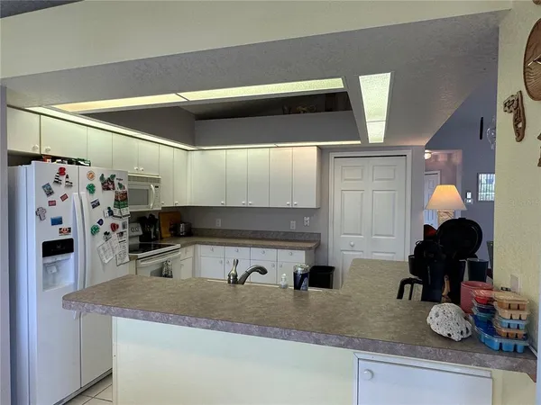 a kitchen with a sink a counter and cabinets