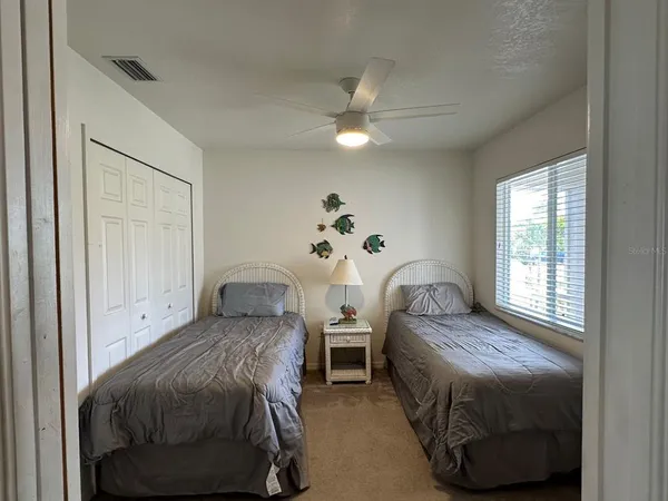 a bedroom with two beds and a chandelier