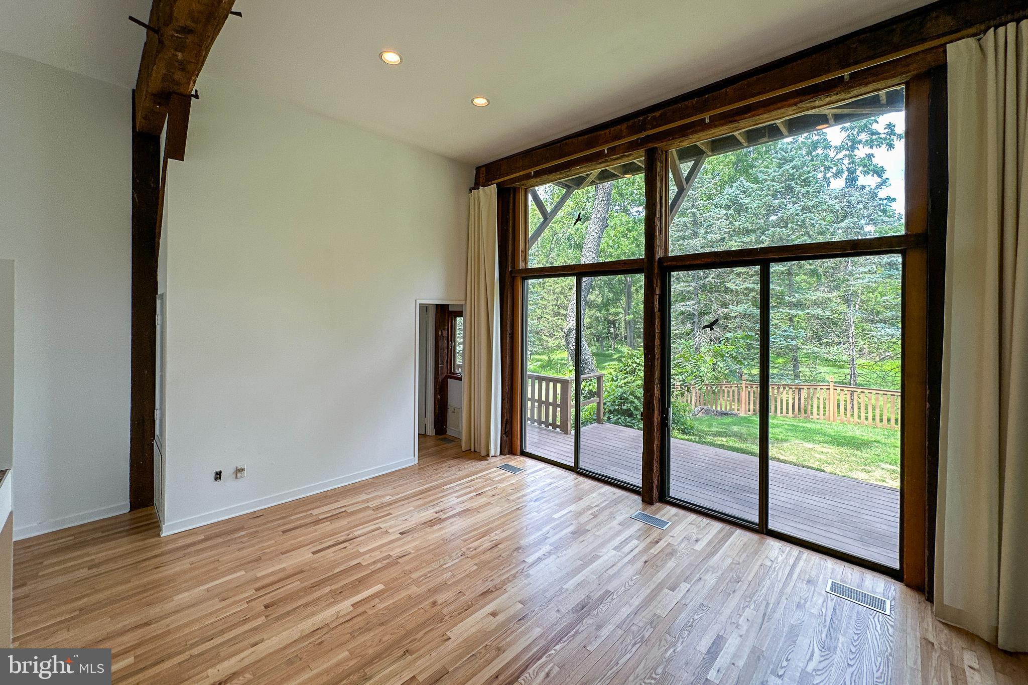 900 Canal Road Princeton, NJ 08540 - Photo 18 of 38 a view of an empty room with wooden floor and a window