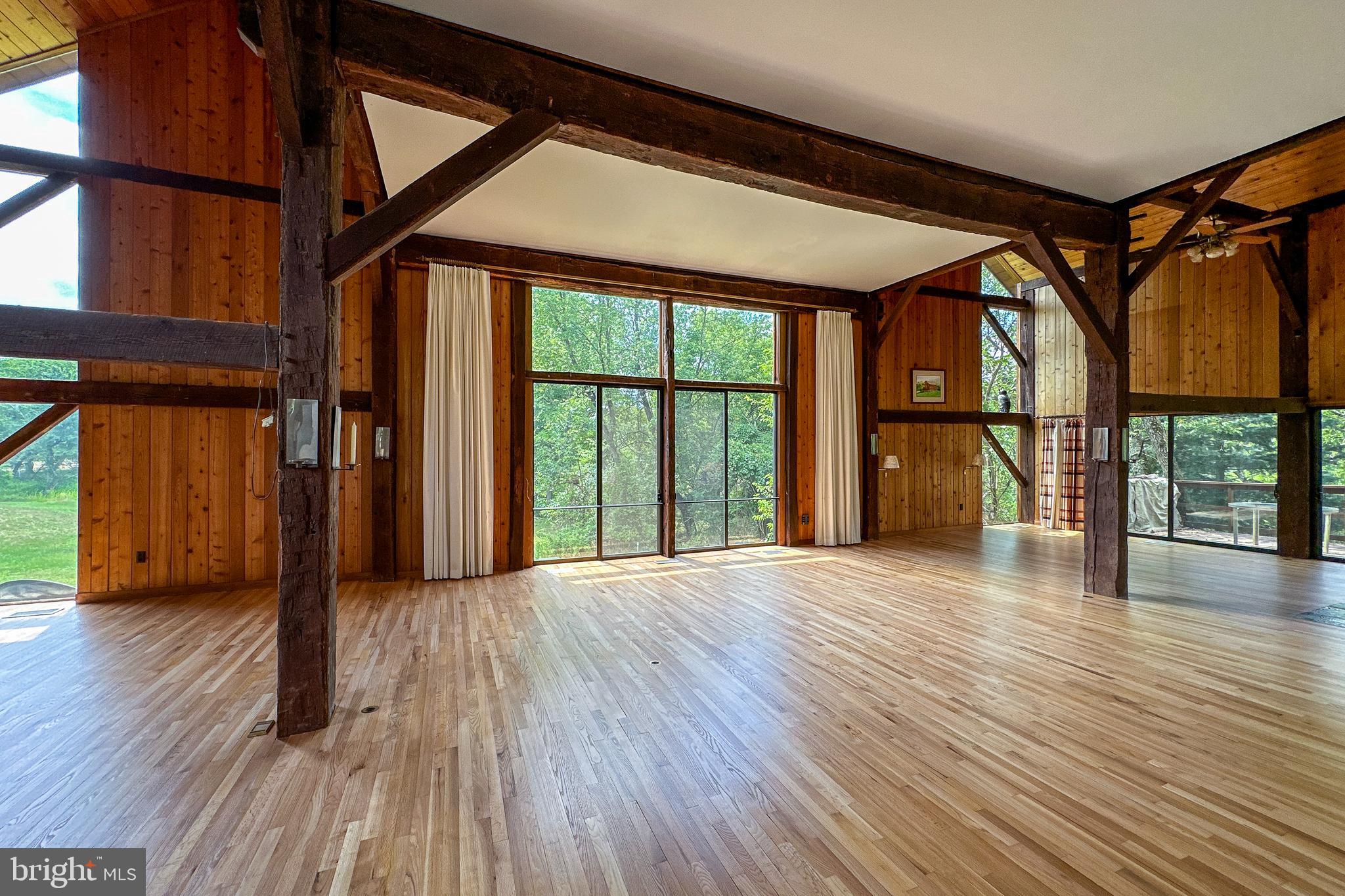 900 Canal Road Princeton, NJ 08540 - Photo 4 of 38 a view of an empty room with wooden floor and a window