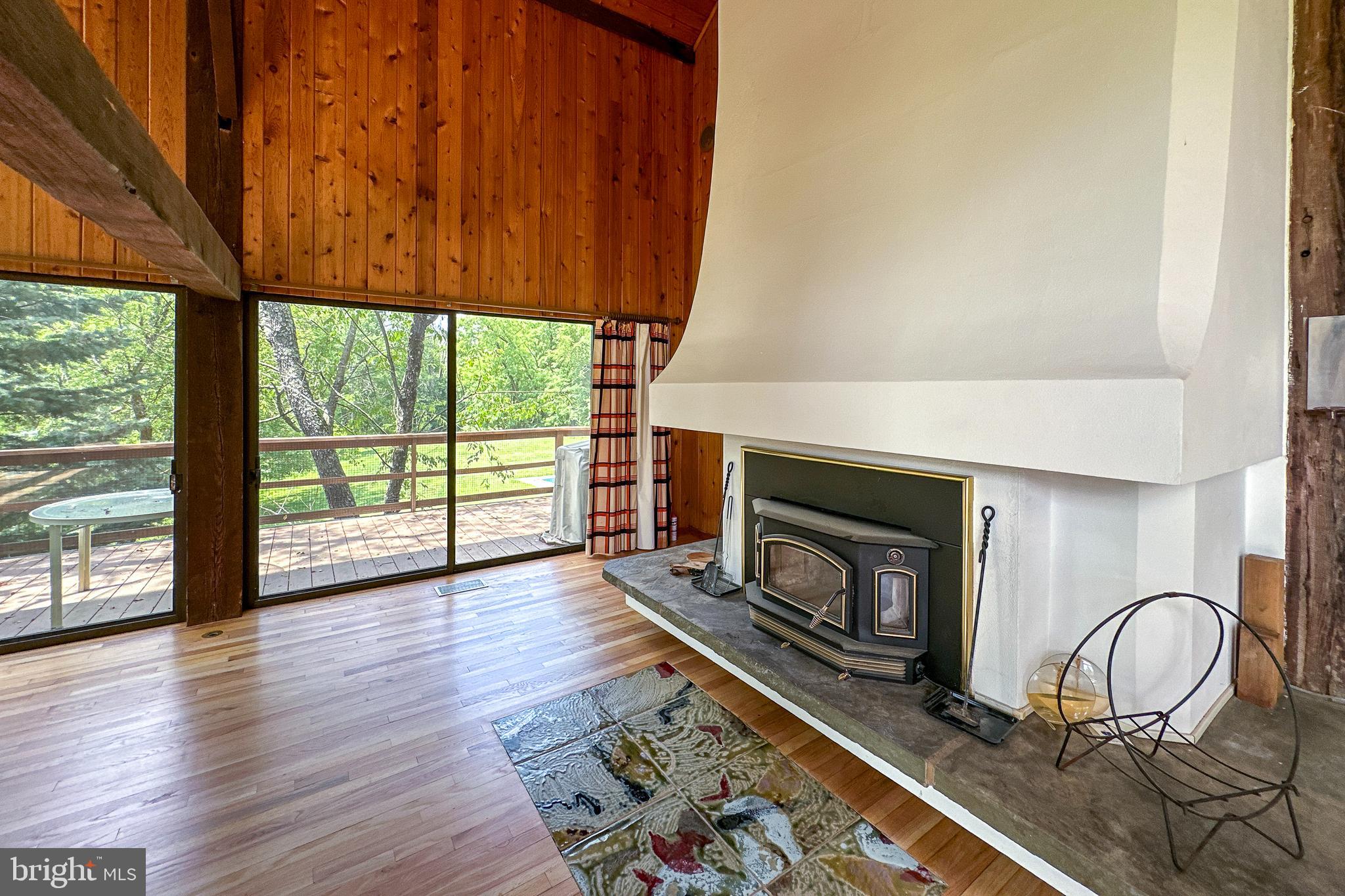 900 Canal Road Princeton, NJ 08540 - Photo 9 of 38 an empty room with wooden floor fireplace and windows