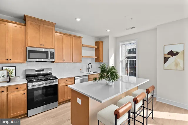 a kitchen with a stove a sink and a refrigerator
