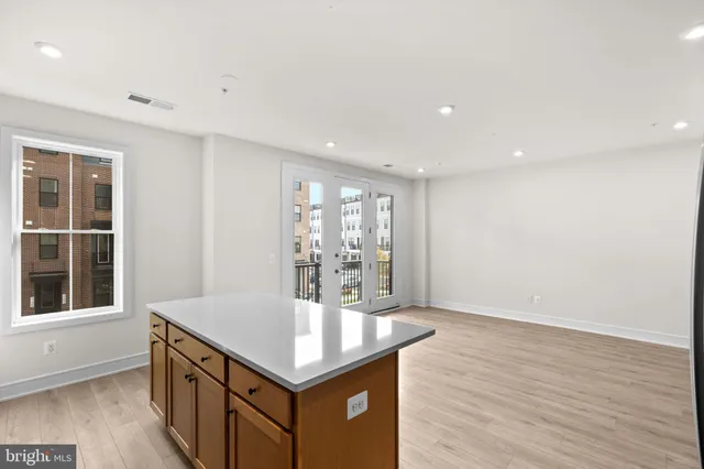 a kitchen with a sink cabinets and wooden floor