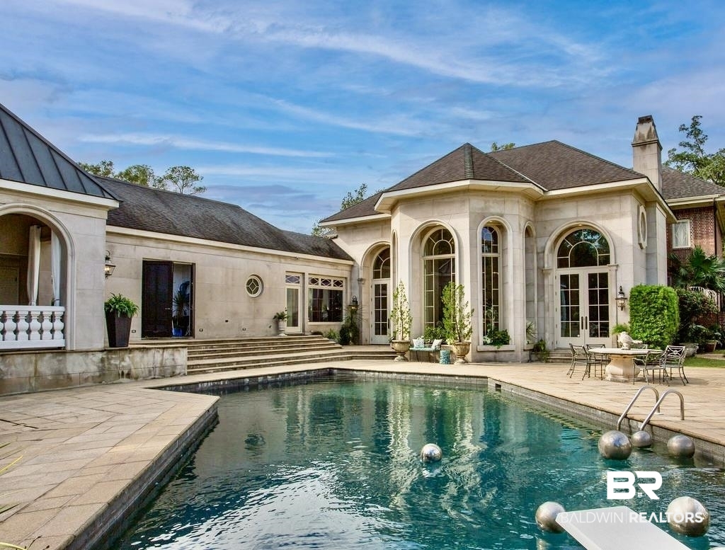150 Austill Avenue Mobile, AL 36608 - Photo 39 of 39 Inviting outdoor pool with a diving board, surrounded by stone paving and architectural steps