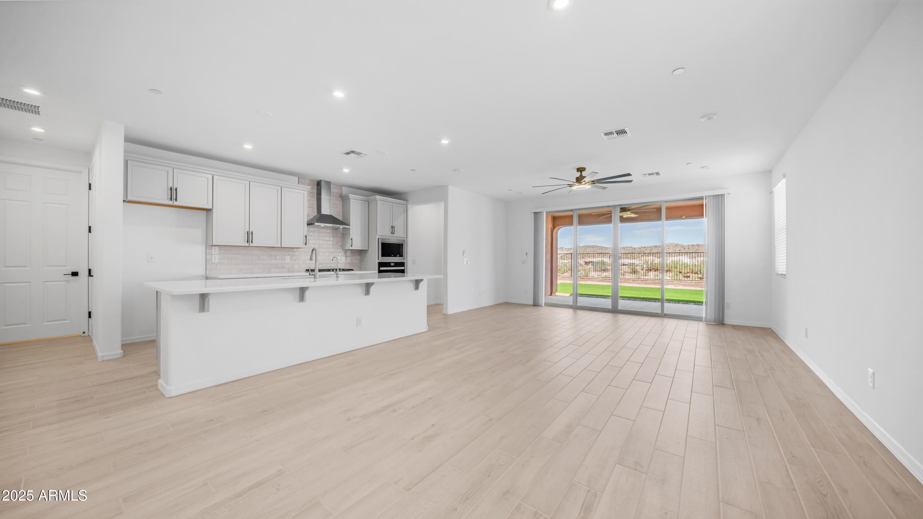 13362 West Eagle Feather Road Peoria, AZ 85383 - Photo 11 of 32 a view of kitchen with wooden floor