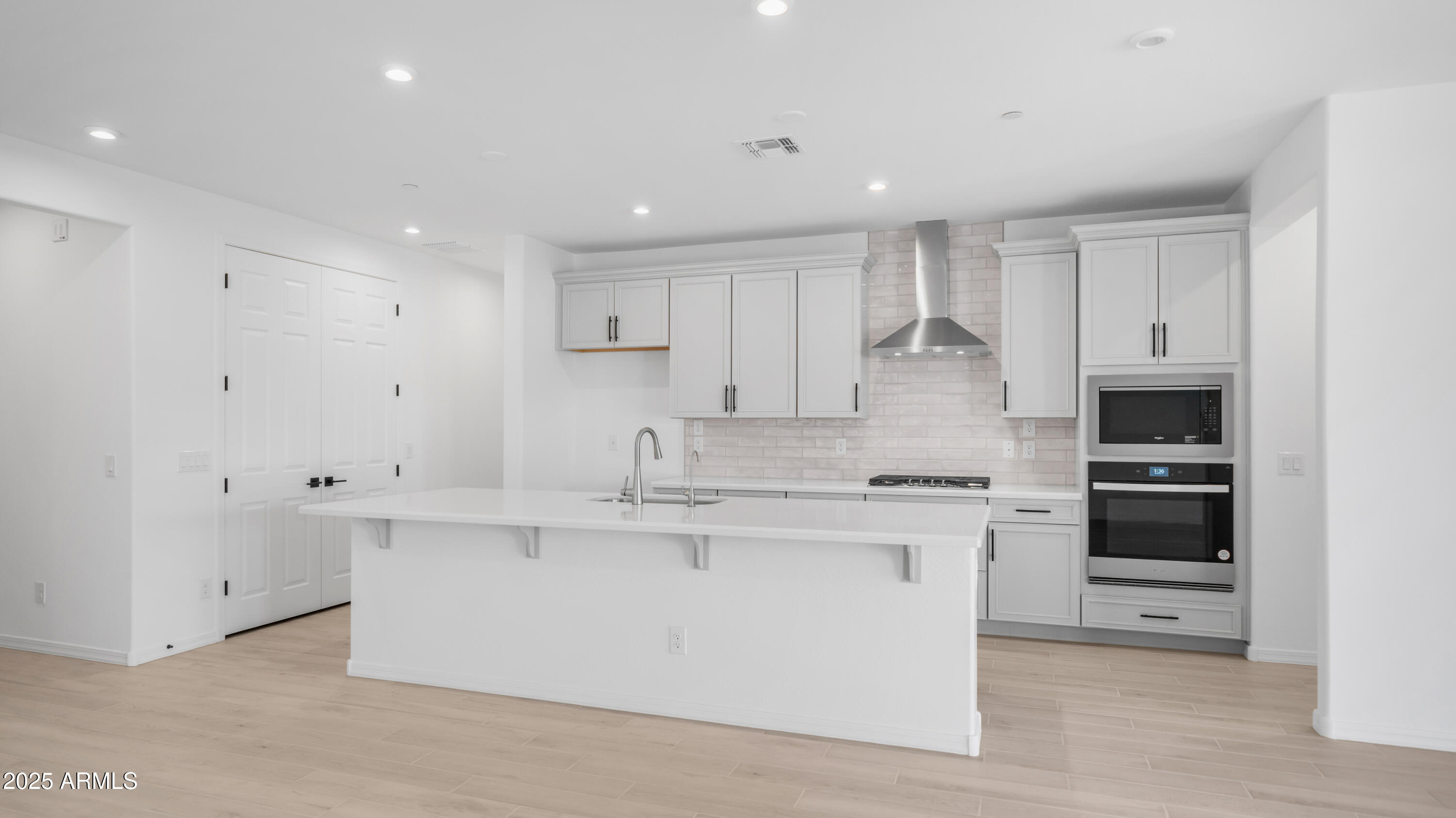 13362 West Eagle Feather Road Peoria, AZ 85383 - Photo 13 of 32 a kitchen with stainless steel appliances granite countertop a stove a sink and a refrigerator