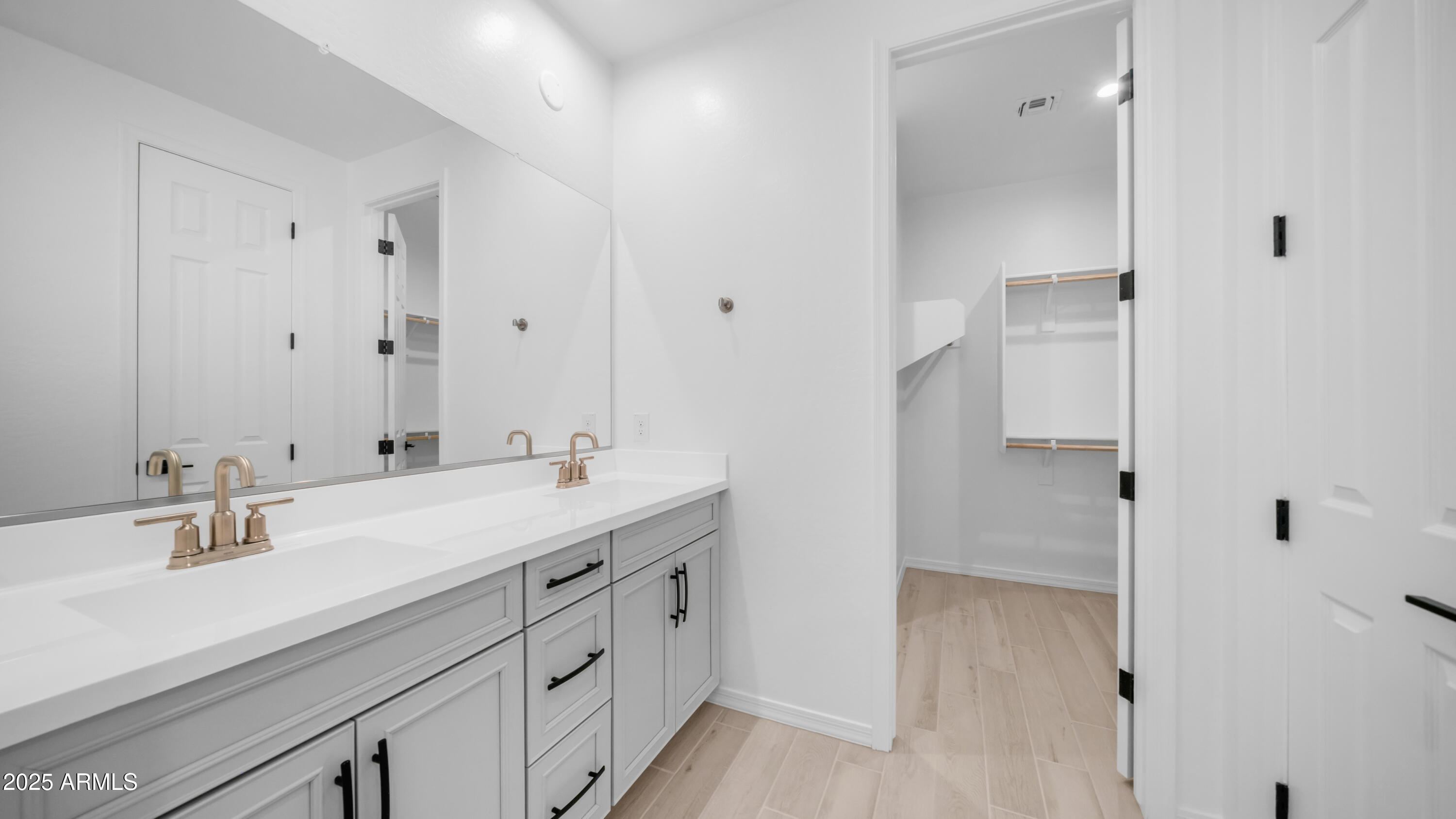 13362 West Eagle Feather Road Peoria, AZ 85383 - Photo 22 of 32 a spacious bathroom with a double vanity sink a mirror and shower
