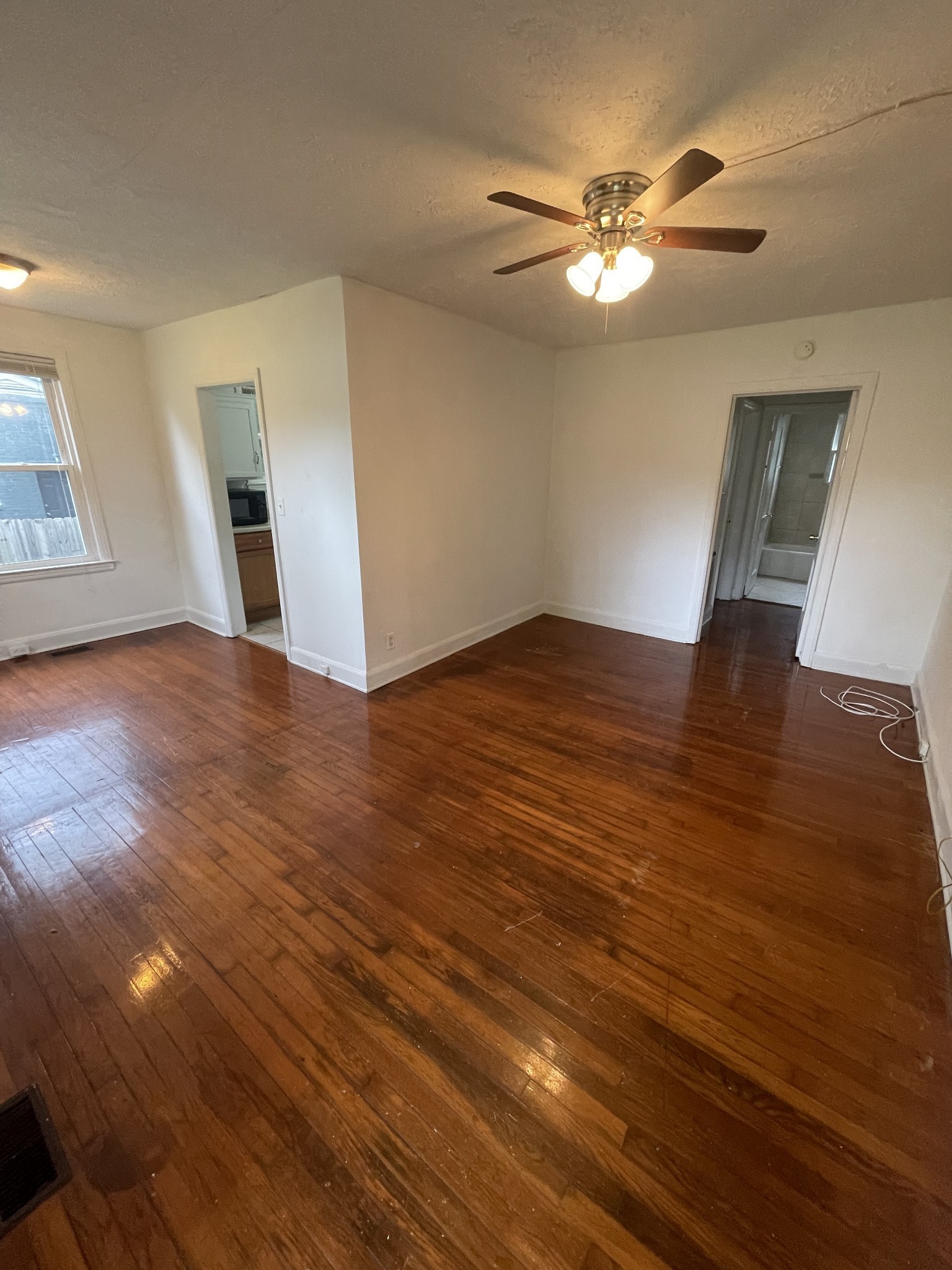 3452 Mt Tabor Road Murfreesboro, TN 37127 - Photo 2 of 5 a view of an empty room with wooden floor and a ceiling fan