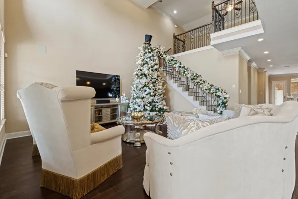 a living room with furniture and a chandelier