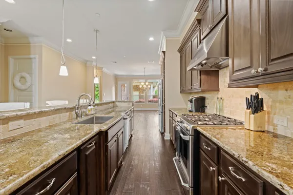 a kitchen with stainless steel appliances granite countertop stove top oven a sink and dishwasher