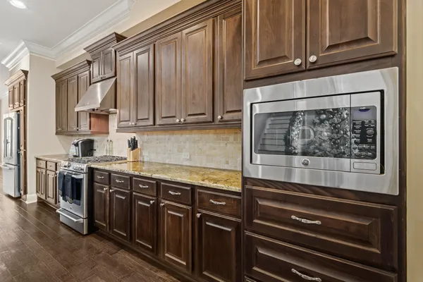 a kitchen with stainless steel appliances granite countertop a stove and a microwave