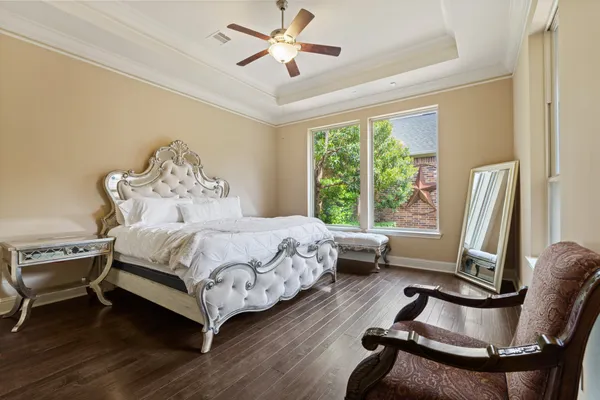 a bedroom with a bed chairs and a window