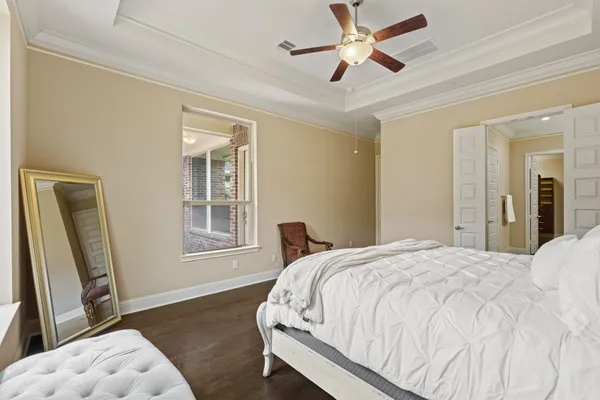a bedroom with a bed and a large mirror