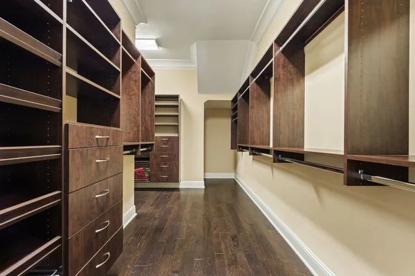 a view of walk in closet with clothes and shoes