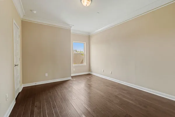 a view of an empty room with wooden floor