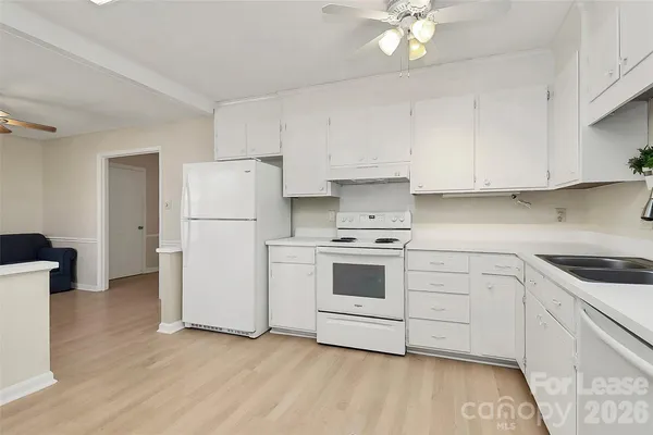 a kitchen with a white cabinets and white appliances