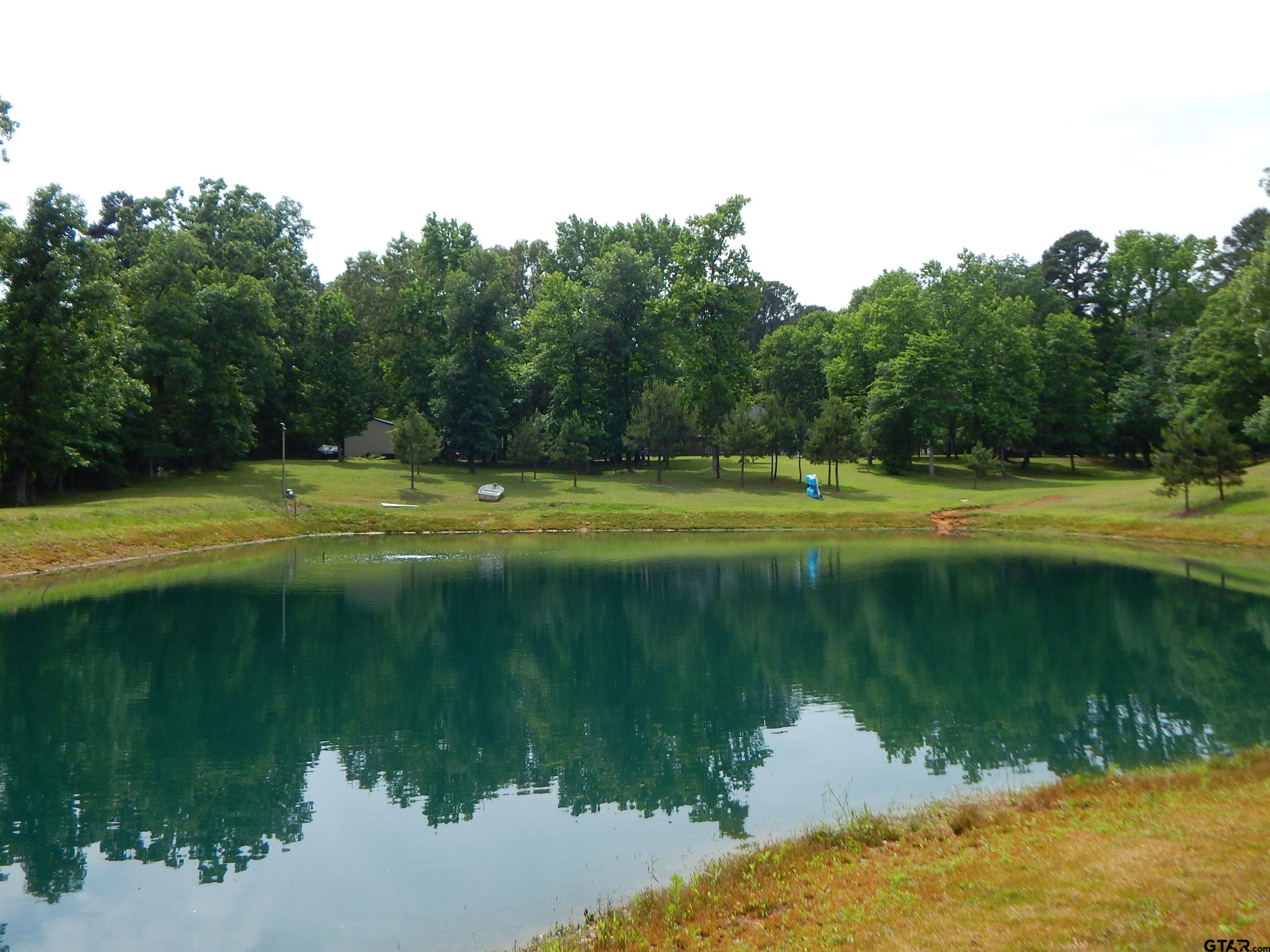 1106 Tall Timbers Road Gilmer, TX 75645 - Photo 5 of 28 a view of a lake with a big yard