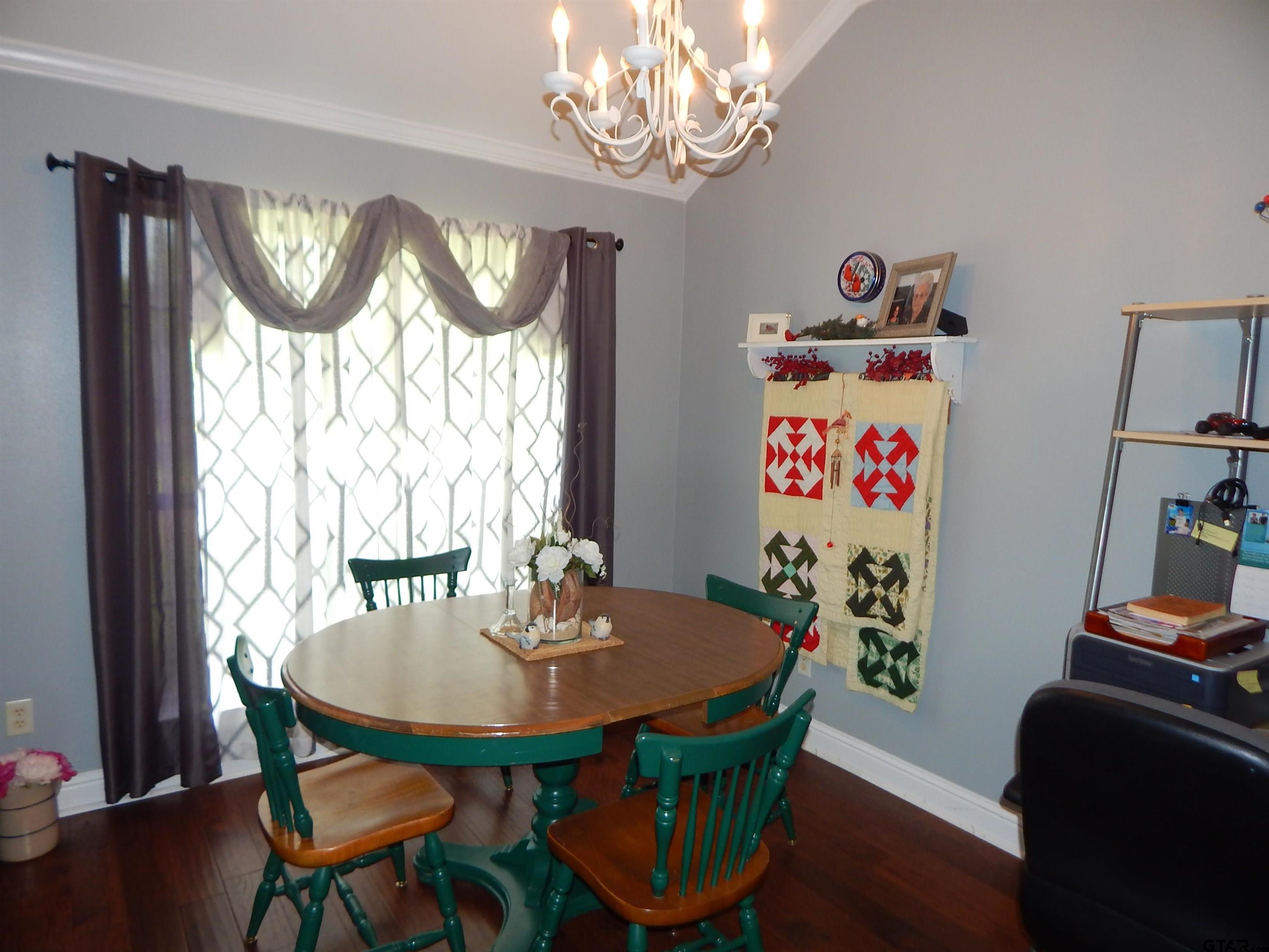 1106 Tall Timbers Road Gilmer, TX 75645 - Photo 9 of 28 a view of a dining room with furniture window and wooden floor
