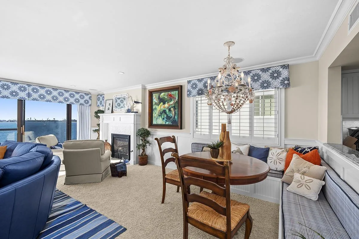 3828 Riviera Drive, Unit 2B San Diego, CA 92109 - Photo 24 of 74 a dining room with furniture a chandelier and wooden floor