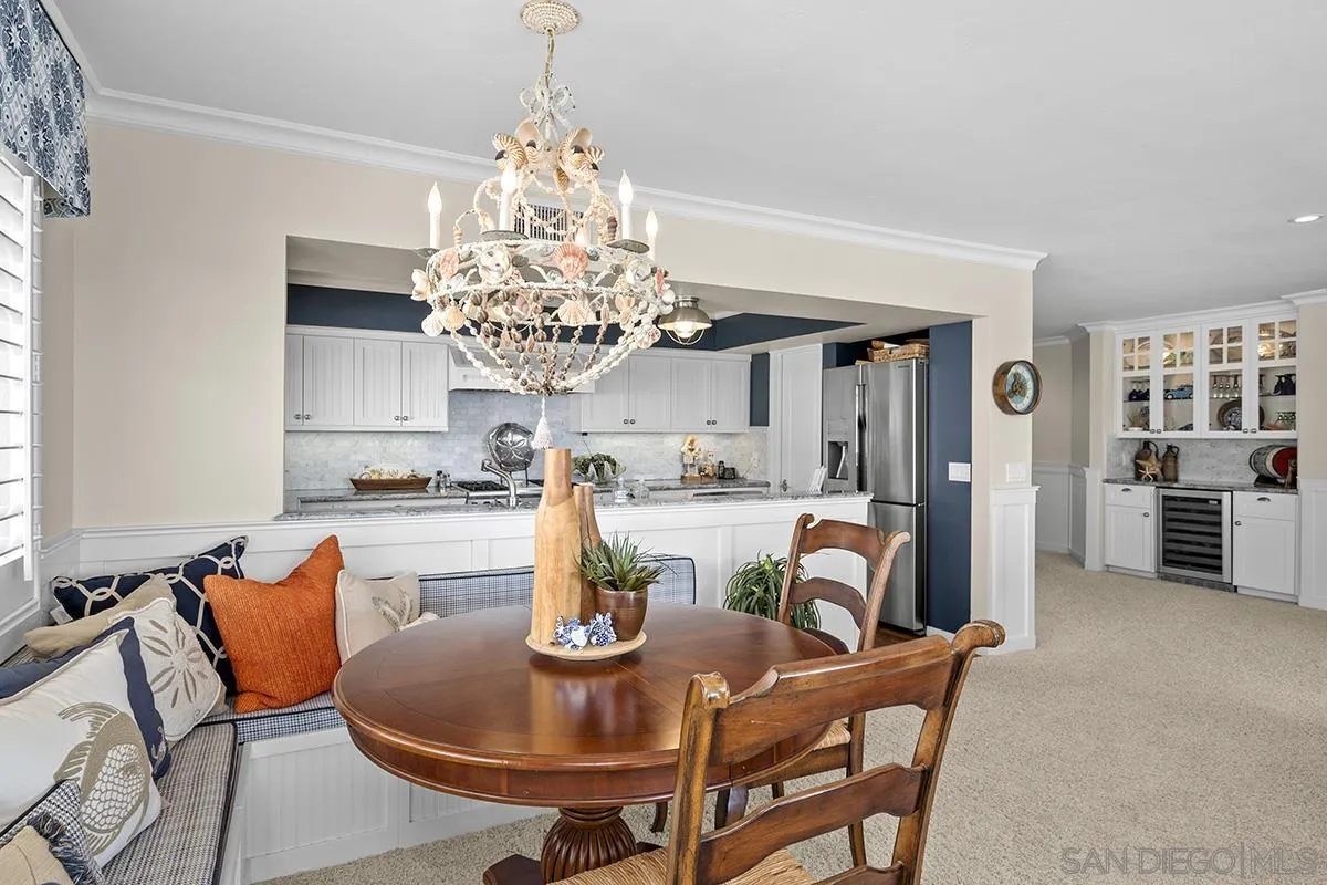 3828 Riviera Drive, Unit 2B San Diego, CA 92109 - Photo 26 of 74 a view of a dining room with furniture and chandelier