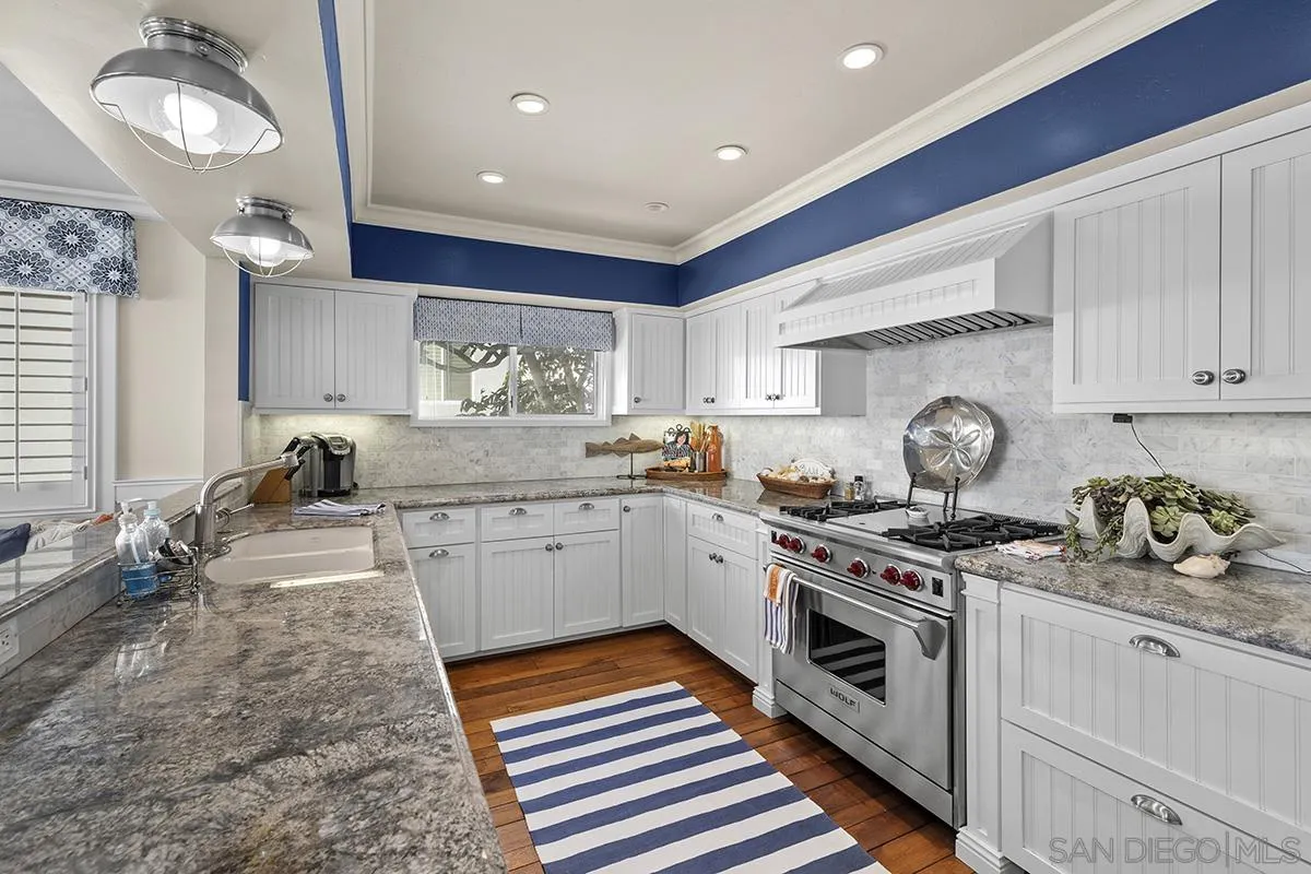3828 Riviera Drive, Unit 2B San Diego, CA 92109 - Photo 30 of 74 a kitchen with a stove oven and cabinets