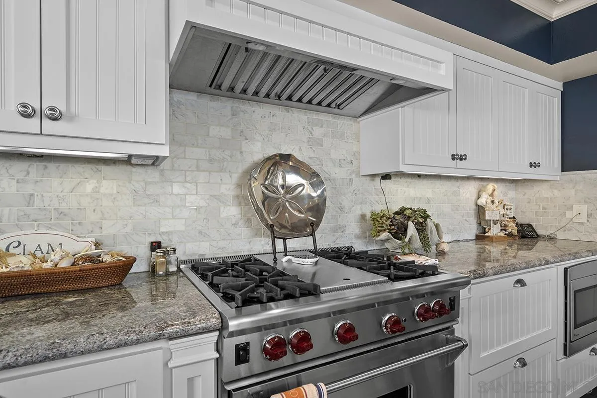 3828 Riviera Drive, Unit 2B San Diego, CA 92109 - Photo 31 of 74 a stove top oven sitting inside of a kitchen
