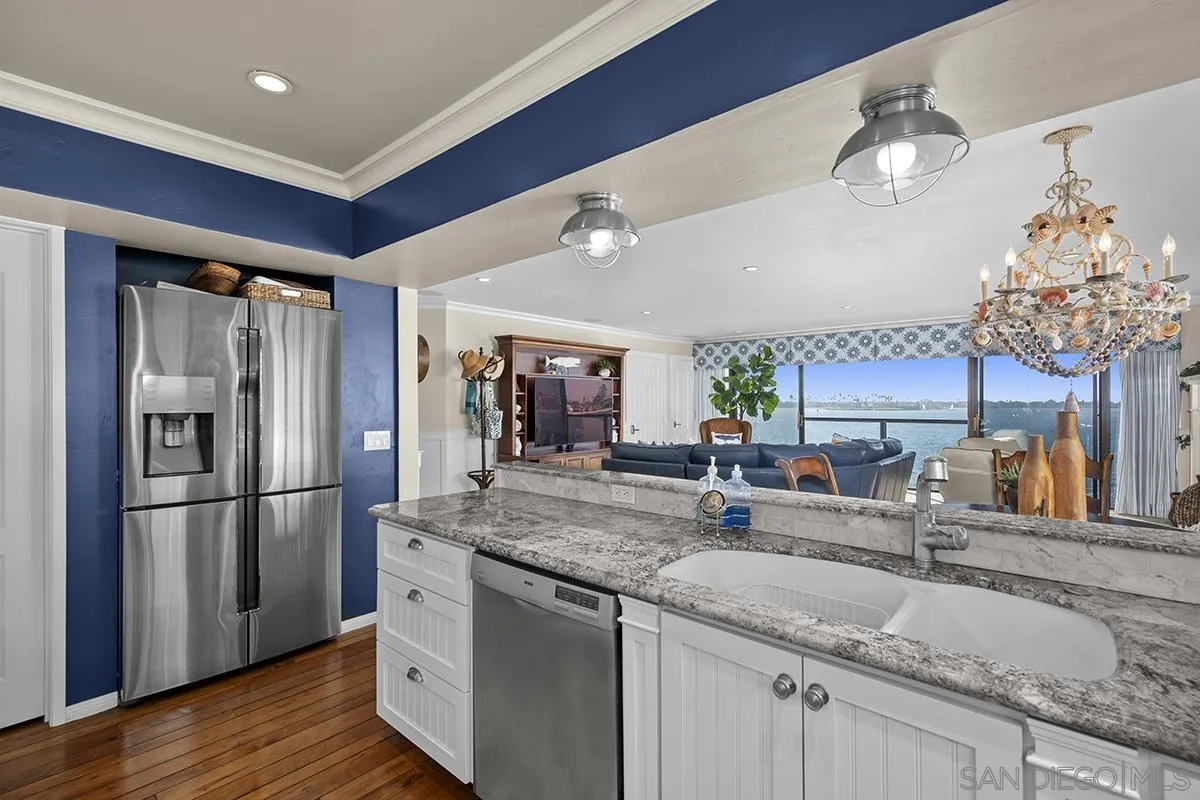 3828 Riviera Drive, Unit 2B San Diego, CA 92109 - Photo 32 of 74 a kitchen with stainless steel appliances granite countertop a sink refrigerator and cabinets
