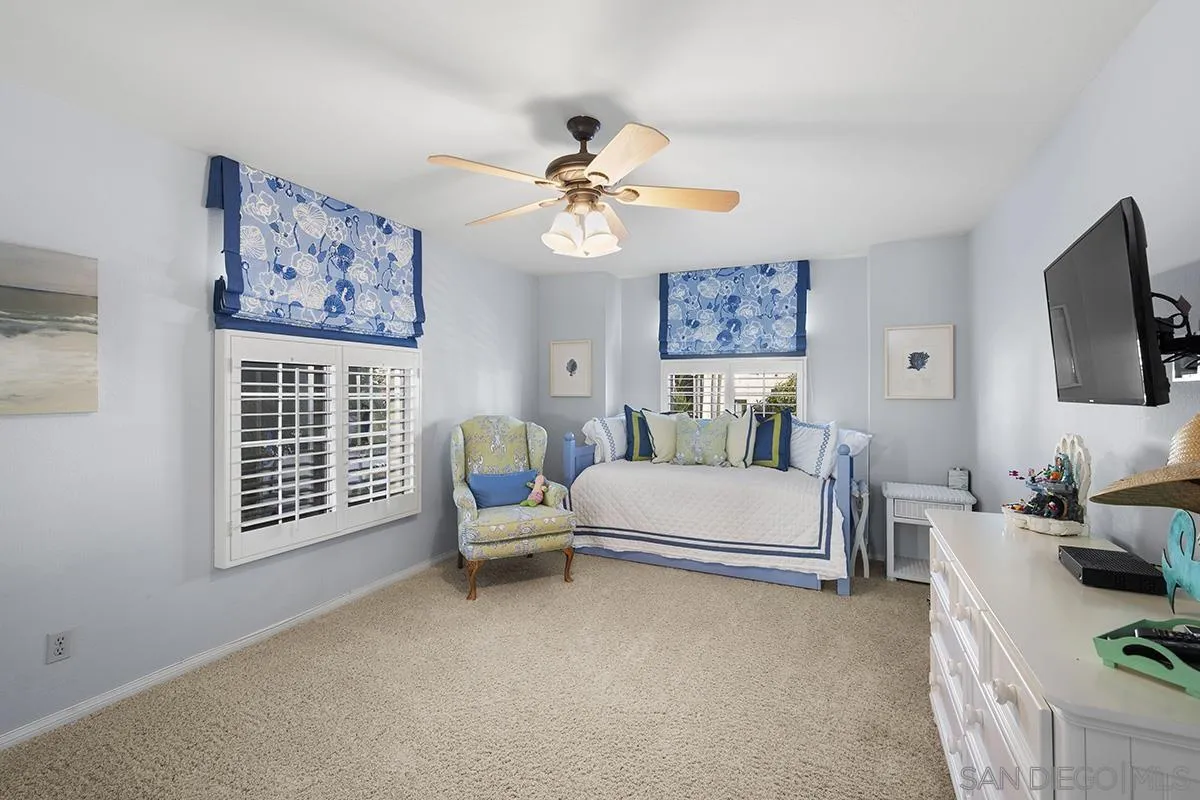 3828 Riviera Drive, Unit 2B San Diego, CA 92109 - Photo 43 of 74 a bedroom with furniture and a window