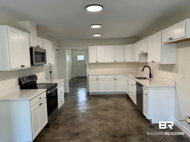 22035 7th Street Silverhill, AL 36576 - Photo 16 of 21 Kitchen with stainless steel appliances, sink, and white cabinetry