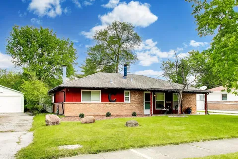 a front view of a house with a yard porch and outdoor seating