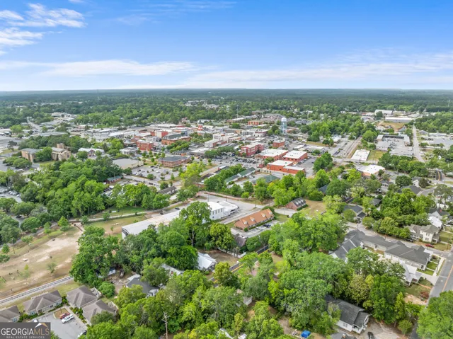 an aerial view of residential building with green space