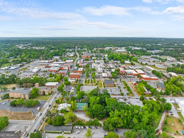 an aerial view of residential building with green space