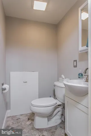 a white toilet sitting next to a bathroom sink