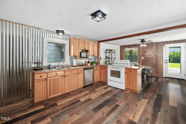 a living room with furniture a fireplace and a chandelier
