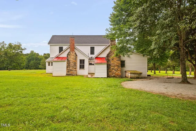 a view of a house with a yard and lake view