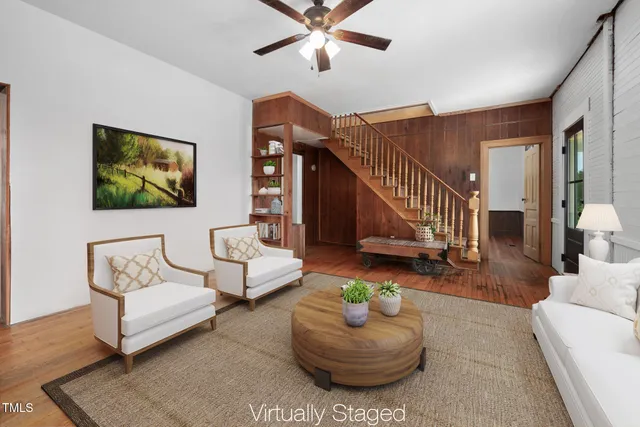 a living room with furniture and a painting