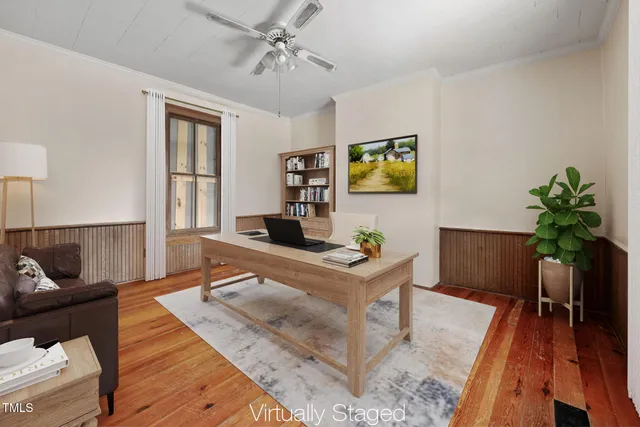 a living room with furniture a window and a flat screen tv